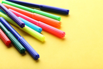 Felt-tip pens on a yellow background