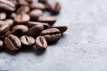 Roasted coffee beans on a grey table