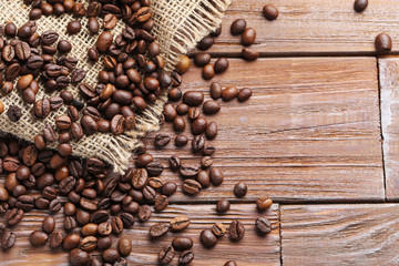 Roasted coffee beans on a brown wooden table