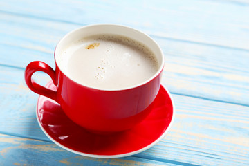 Cup of coffee on a blue wooden table
