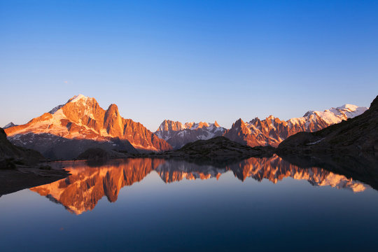 beautiful nature background, mountain landscape at sunset, panoramic view of Alps with reflection in lake
