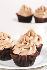 Tasty cupcakes on a white plate