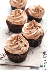 Tasty cupcakes on a white wooden table