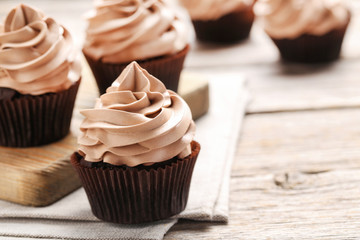 Tasty cupcakes on a grey wooden table