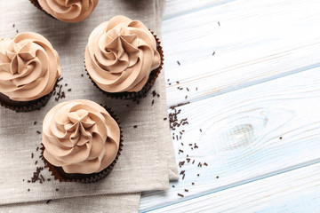 Tasty cupcakes on a white wooden table