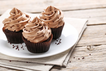 Tasty cupcakes on a grey wooden table