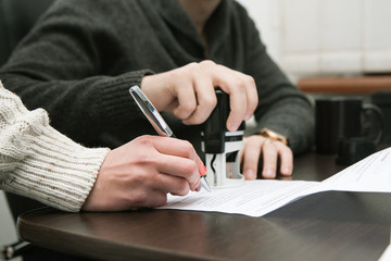 male and female hand sign an agreement