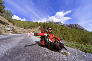 Fototapeta premium Summer hiking in the mountains with a backpack .