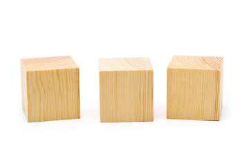 Three brown wooden cubes lined up