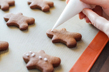 Decorating Freshly baked gingerbread man on the table