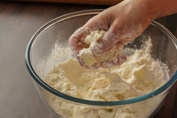 Mixing fresh dough mix with the hands 