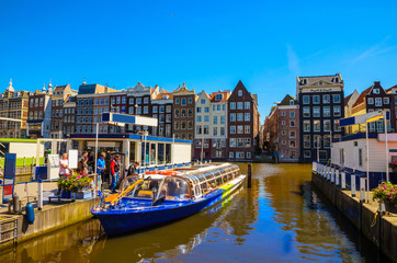 Traditional old buildings and and boats in Amsterdam, Netherlands