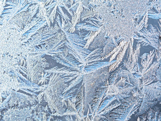 Frost on glass, ice patterns on winter glass.