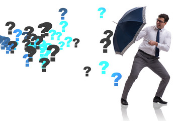 Uncertainty concept with businessman and question marks