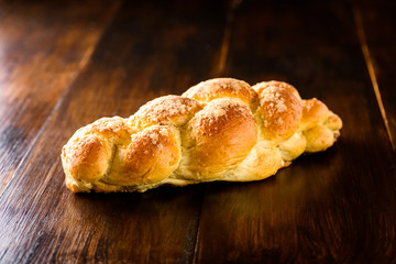 Challah bread on wooden table
