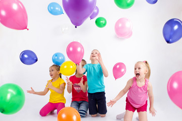 Group of joyful little kids having fun at birthday party. Isolated on white background. Holidays,...