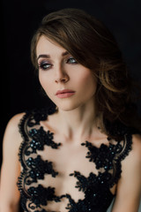 Close up. Individuality. Thoughtful Elegant Lady in Black Prom Evening Dress. Studio retouched photo.