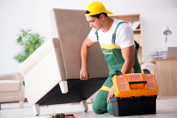 Furniture repairman repairing armchair at home