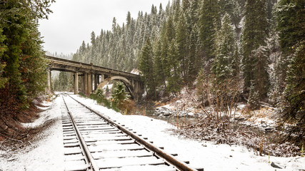 Rainbow bridge in Idaho with train tracks in winter