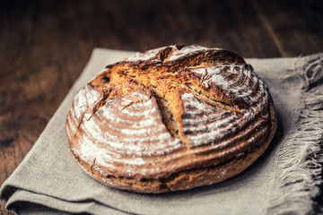 Bread.Fresh round crisp bread with caraway on wooden table.