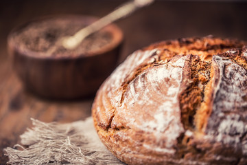 Bread.Fresh round crisp bread with caraway on wooden table.
