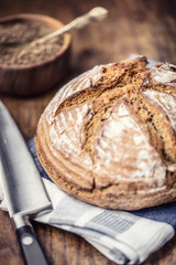 Bread.Fresh round crisp bread with caraway on wooden table.