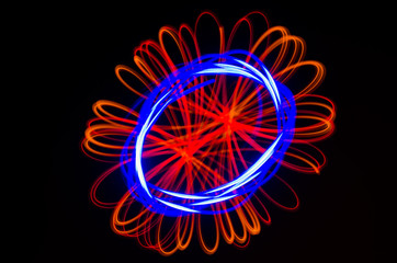 Light spiral, red and blue lines on a black background