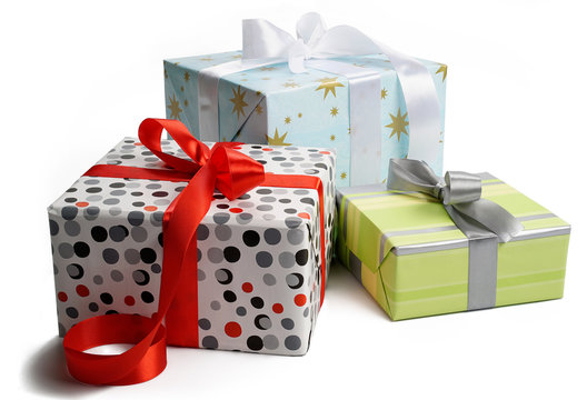Set of gift boxes wrapped in colorful paper, tied with a ribbons. Isolated on white background.