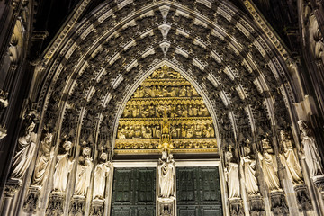 Statues and gothic arches of Cologne Cathedral in Germany