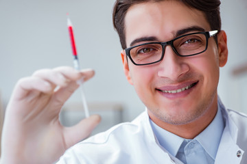 Young doctor with the syringe