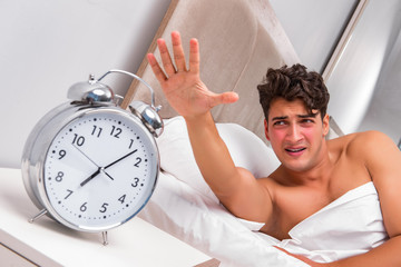 Man having trouble waking up in the morning