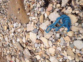 Old blue rope on the beach