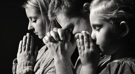 Praying family. Man, woman and child. - obrazy, fototapety, plakaty