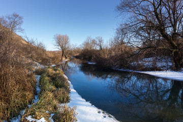 Winter river landscape at bright sunny day