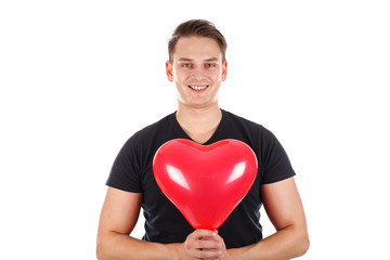 Handsome guy holding a heart-shaped balloon