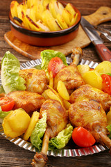 Chicken legs and baked dill potatoes with vegetable salad