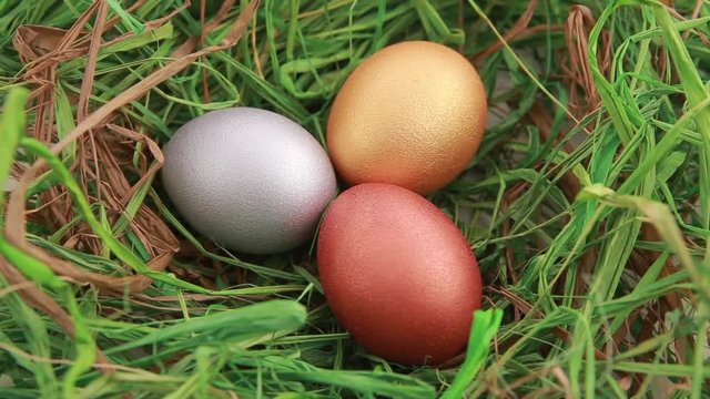Three Golden Easter eggs on grass