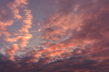 colorful sunset with pocked clouds .