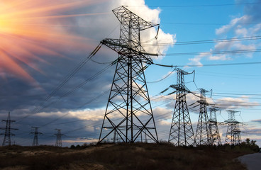  high-voltage  power lines at sunset .