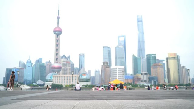 Asian woman running in city of Shanghai, China on famous boardwalk with skyline. Urban city lifestyle. Active woman runner exercising outside jogging on the Bund.