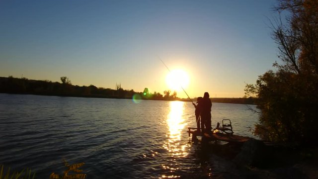 Fishermans on the river. Sunset and shining waves. Ukraine. 4K, Ultra HD video.