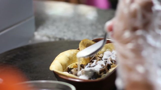 Chef pouring sauce to al forno pancake