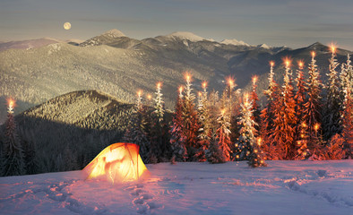 Snowy tent illuminated