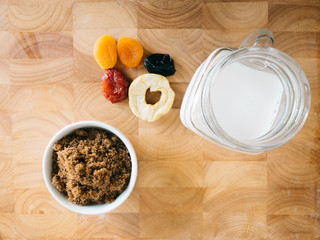 Brown sugar ingredients with dried apricot pear and plum fruit butter and milk