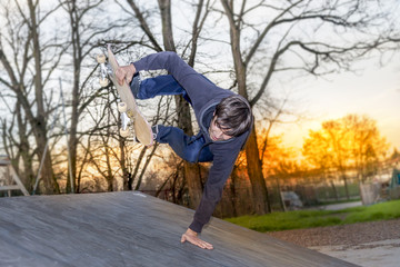 young skateboarder jumping on a ramp outdoor