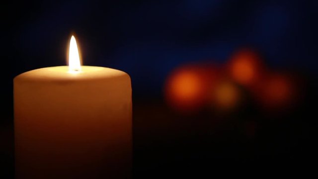 Easter candle with ornaments in the dark