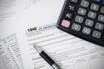 US tax form 1040 with pen and calculator