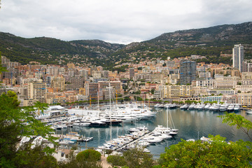 Principality of Monaco. View of the seaport and the city of Monte Carlo with luxury yachts and sail boats 
