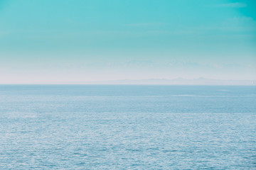Obraz premium Calm Sea Ocean And Blue Clear Sky Background. Gently Blue Color