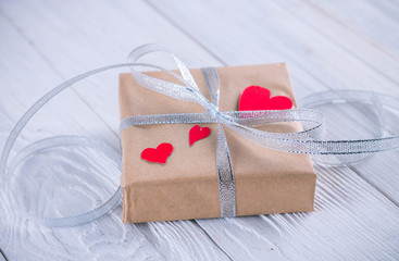 Valentines day gift wrapping on wooden background.